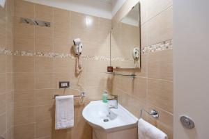a bathroom with a sink and a mirror at Monticello apartment via Cavour in Rome +15 photos
