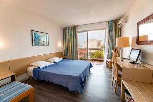 a hotel room with a bed and a window at Hotel du Port in Canet-en-Roussillon