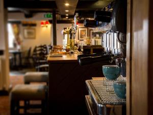 a kitchen with a counter and a bar with aperature at The Barrel Inn in Eyam