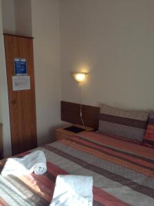 A bed or beds in a room at The Premier Lodge 