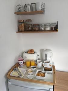 a tray of food on a counter with breakfast foods at Basingstoke En Suite Room in Garden Annex in Basingstoke