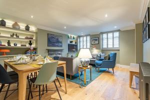 a dining room and living room with a table and chairs at Beaches Brighton - Luxury Seafront Accommodation in Brighton & Hove