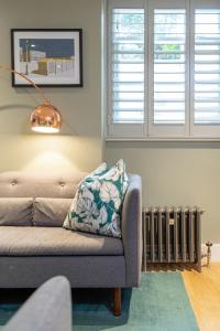 a living room with a couch and a radiator at Beaches Brighton - Luxury Seafront Accommodation in Brighton & Hove