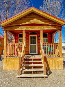 a wooden cabin with stairs leading to the front door at Healing Waters Resort and Spa in Pagosa Springs