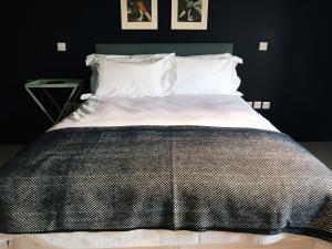 a large bed in a bedroom with black walls at The Bell Inn in Lechlade