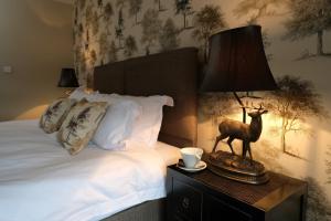 Ένα ή περισσότερα κρεβάτια σε δωμάτιο στο The Queens At Horton +25 φωτογραφίες