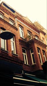 a red brick building with windows on a street at Puffin Boutique - Istanbul in Istanbul