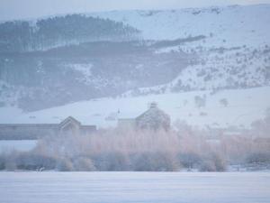 a snow covered field with a house in the distance at Blackthorn Gate in Nunthorpe