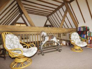 a statue of a horse in a crib with two chairs at Bluebell Farm in Upton upon Severn