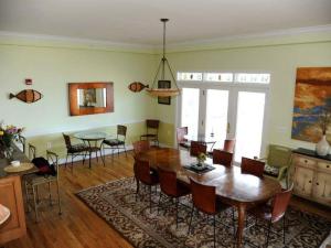 a dining room with a wooden table and chairs at Blue Heron Inn - A Bed and Breakfast LLC in Solomons