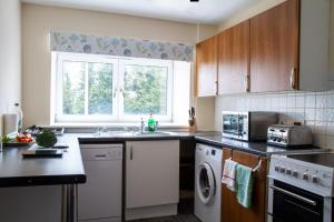 a kitchen with a sink and a dishwasher at Carvetii - Borthwick House - Ground floor flat in Kinghorn
