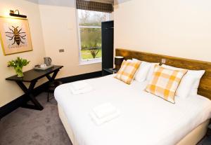 a bedroom with a bed and a table and a window at Bowling Green in Manchester