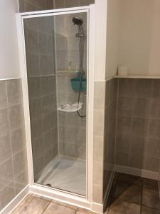 a shower with a glass door in a bathroom at Breeze Guest House in Bootle