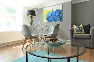 a living room with a glass table and chairs at BrickSage Rooms, King's Lynn The Walks in King's Lynn