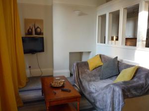 a living room with a couch and a table at Paragon Serviced Apartments in Cheltenham