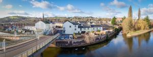 a small town next to a river with a bridge at Bridge Guest House in Tiverton