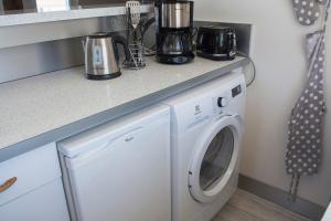 a laundry room with a washer and dryer under a counter at la belle vue le diamant des yeux mer et golf front mer in Étretat