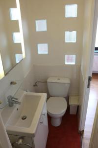 a bathroom with a white toilet and a sink at Brussels BnB in Brussels