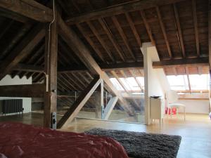 a bedroom with a bed and a room with wooden ceilings at 45 Brewhouse - Royal William Yard in Plymouth