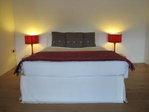 1 dormitorio con 1 cama blanca y 2 lámparas en 45 Brewhouse - Royal William Yard, en Plymouth