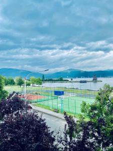 a view of a soccer field with a river in the background at Apartament Sunshine in Orşova