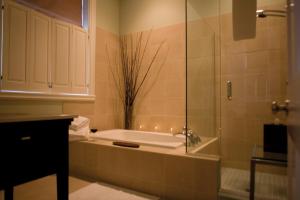 a bathroom with a tub and a sink with candles at The Vanderbilt, Auberge Resorts Collection in Newport