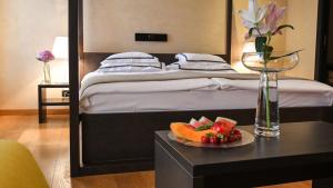 Posteľ alebo postele v izbe v ubytovaní Heritage Hotel Kukuriku