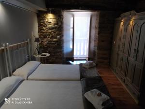 A bed or beds in a room at Albergue Atrio