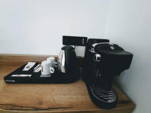a black mixer sitting on top of a wooden counter at Hôtel Casa Mea in Bastia