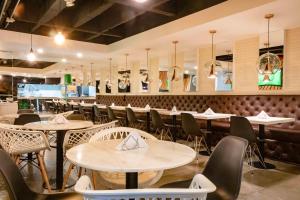 a restaurant with tables and chairs and a bar at Lleras Green Hotel in Medellín +29 photos