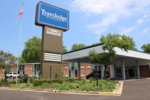 a building with a sign in front of it at Travelodge by Wyndham Water's Edge Hotel - Racine in Racine
