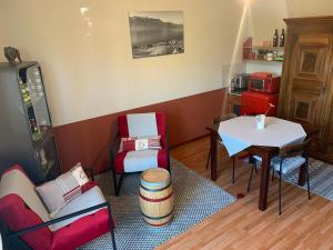 a small living room with a table and chairs at La Gremillette Gourmande Lavaux in Rivaz