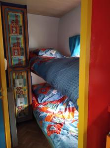 a bedroom with a bunk bed and two twin beds at caradjango , caravane chauffée et climatisée in Lupersat