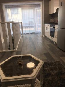 a kitchen with a table in the middle of a room at Columba Livia Guesthouse in Palanga