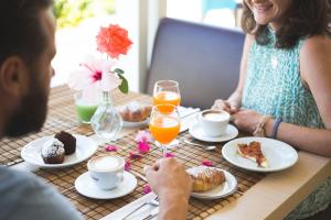 a man and a woman sitting at a table with food at B&B Il Cavaliere Tropea in Santa Domenica