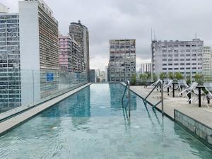 a swimming pool on the roof of a building at Downtown São Luis Akilê in Sao Paulo