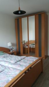 a bedroom with a large bed and a large closet at Ferienwohnung Seeburger See in Seeburg