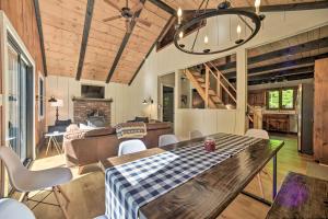 a living room with a wooden table and chairs at Sleek Cabin with Deck, 8 Miles to Mount Snow and Hikes in Wilmington