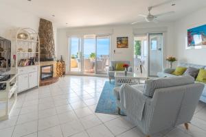 a living room with a couch and a table at Maryvilla Inspiración y Vacaciones - Villa Mascarat in Calpe