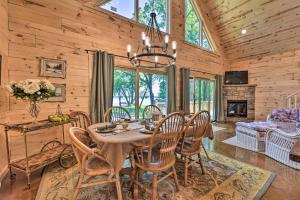 a dining room with a table and chairs and a fireplace at Spacious Pearl Lake Retreat with Yard and Private Dock in Cold Spring