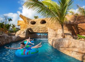 two people in a raft in the water at a water park at Royalton Bavaro, An Autograph Collection All-Inclusive Resort & Casino in Punta Cana