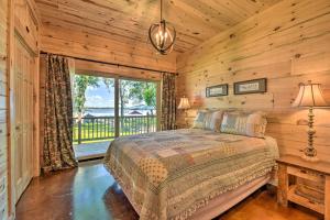 a bedroom with a bed and a large window at Spacious Pearl Lake Retreat with Yard and Private Dock in Cold Spring