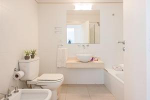 a white bathroom with a toilet and a sink at WONDERFUL APARTMENT - PALERMO WIFI - in Buenos Aires +23 photos