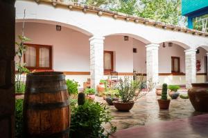 a courtyard with potted plants and a building at Azul Humahuaca Hostal in Humahuaca