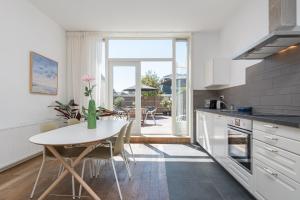 a kitchen with a table and a table and chairs at Charming Apartments in Alkmaar