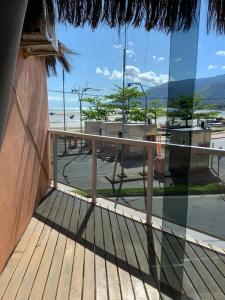 a balcony with a view of the beach and the ocean at Hospedaria Ilhabela - Flats Balsa in Ilhabela +15 photos