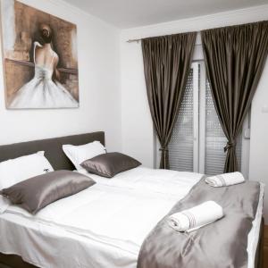 a bedroom with two beds and a picture of a bride at Oasis of Peace in Trebinje