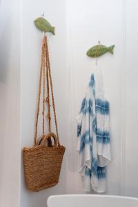 a bathroom with two towels and a basket and a sink at Casa Pompelmo in Lipari +99 photos