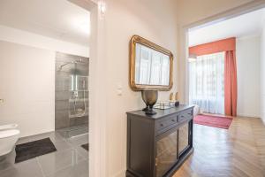 a bathroom with a sink and a mirror and a toilet at MODERNIZED Unique Huge Central Apartment On 135sqm in Budapest +14 photos