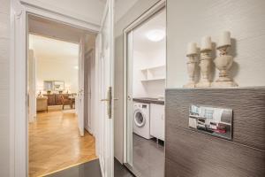 a kitchen and living room with a washer and dryer at MODERNIZED Unique Huge Central Apartment On 135sqm in Budapest